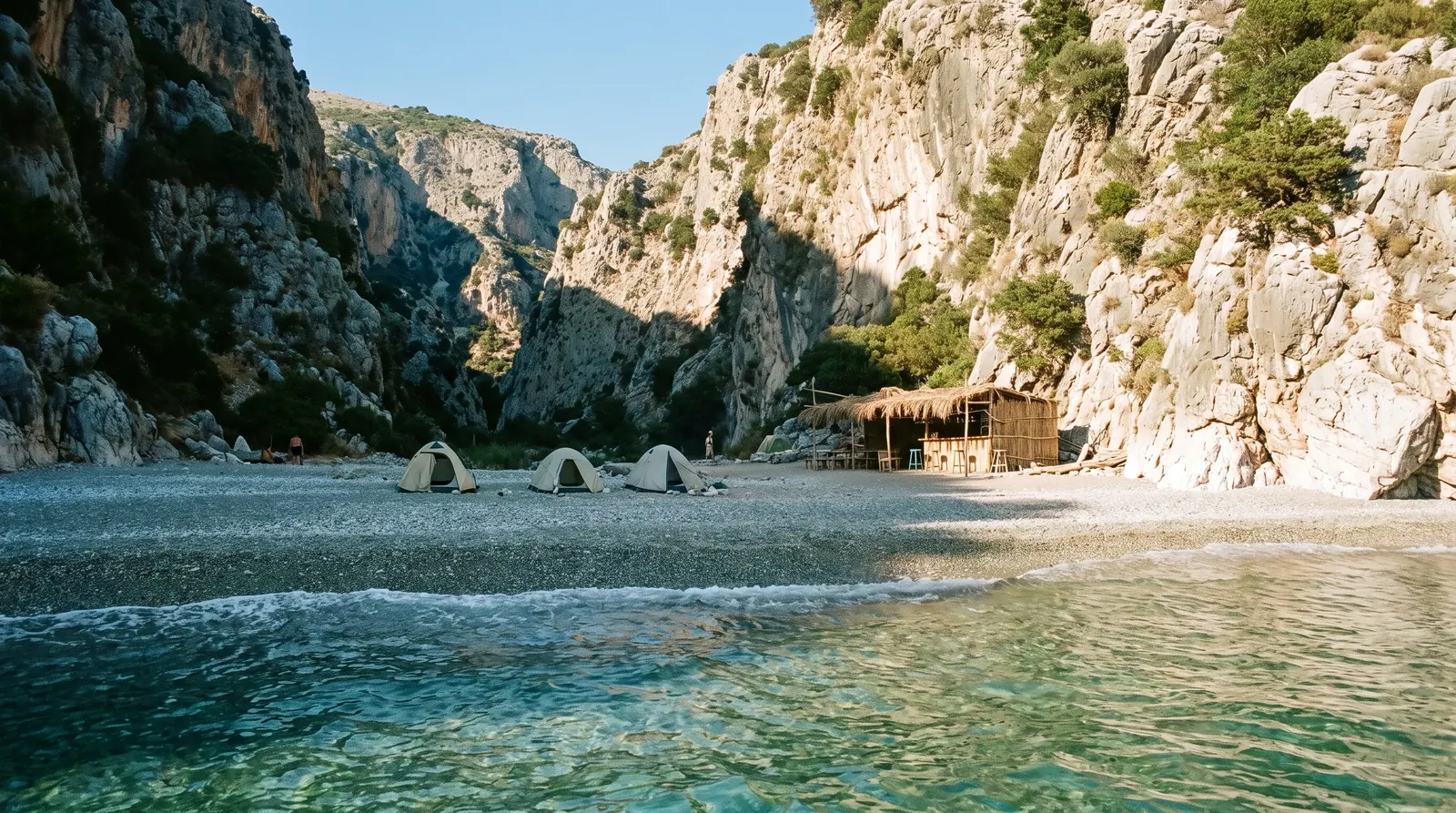 The pebble beach at the mouth of the Gjipe canyon, its walls close on both sides