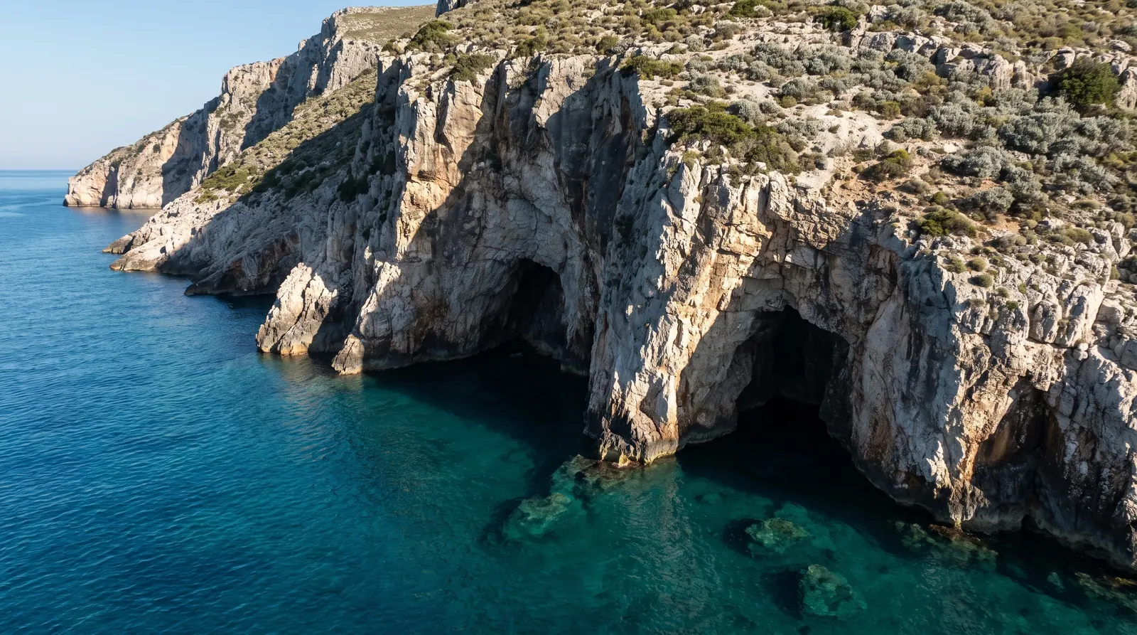 A sea cave at the waterline of the Karaburun peninsula, seen from the water