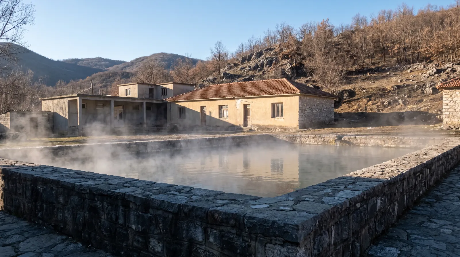 Steam off the stone bathing basin at Llixhat e Peshkopise on a bare winter hillside