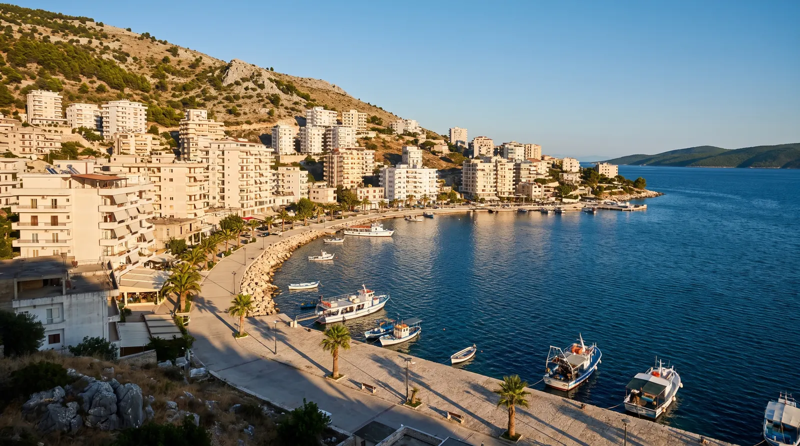 White blocks stacked up the hillside around Sarande's bay, the Corfu channel beyond