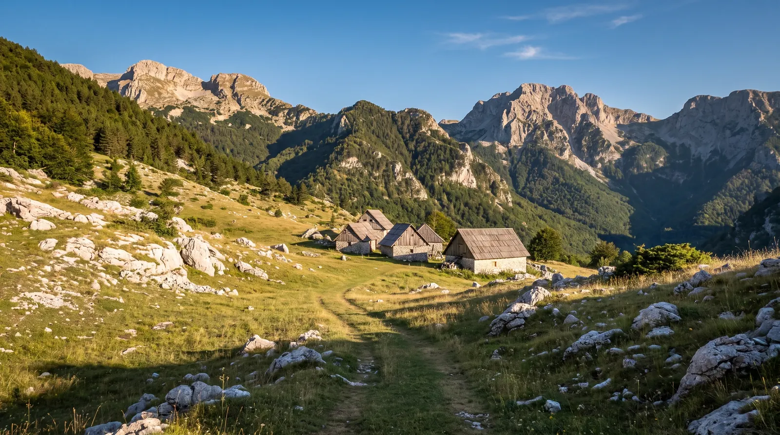 A path crossing high summer pasture toward the few stone houses of Cerem