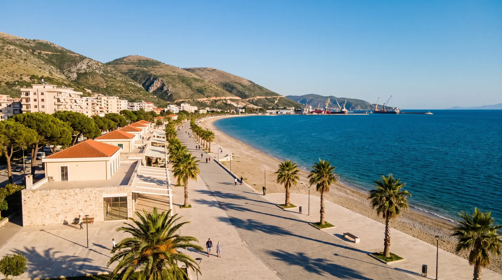 Vlore's seafront promenade with the port cranes at the far end of the bay