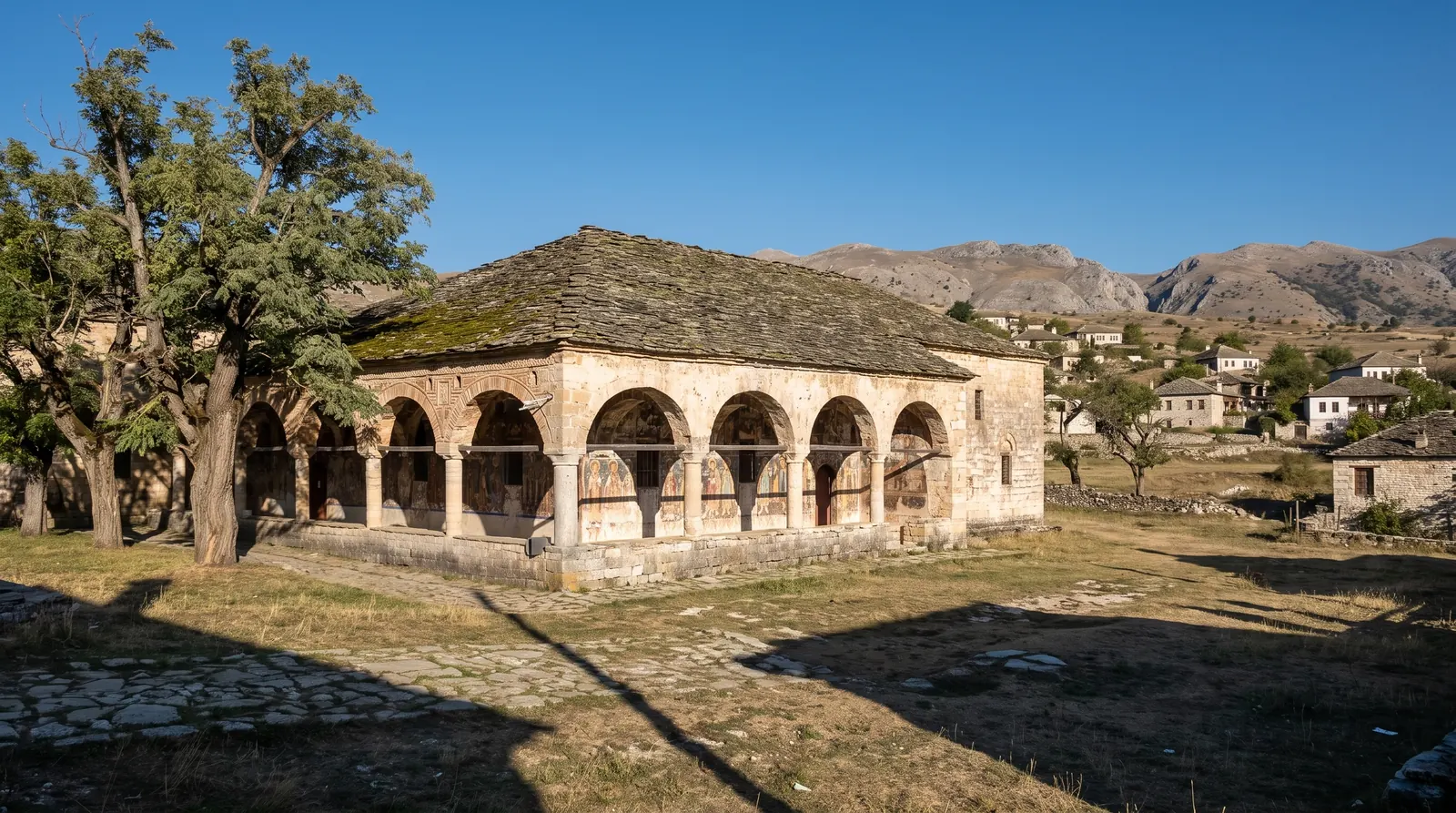One of Voskopoje's surviving stone churches, its heavy roof over an arcaded porch